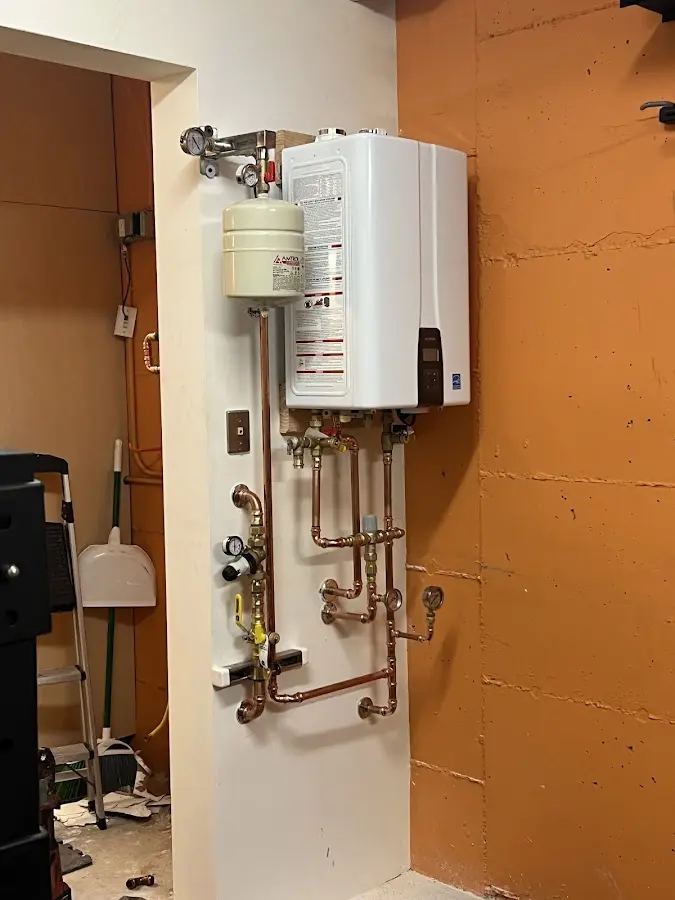 Plumbing technician inspecting water heater connections in Sunnyvale